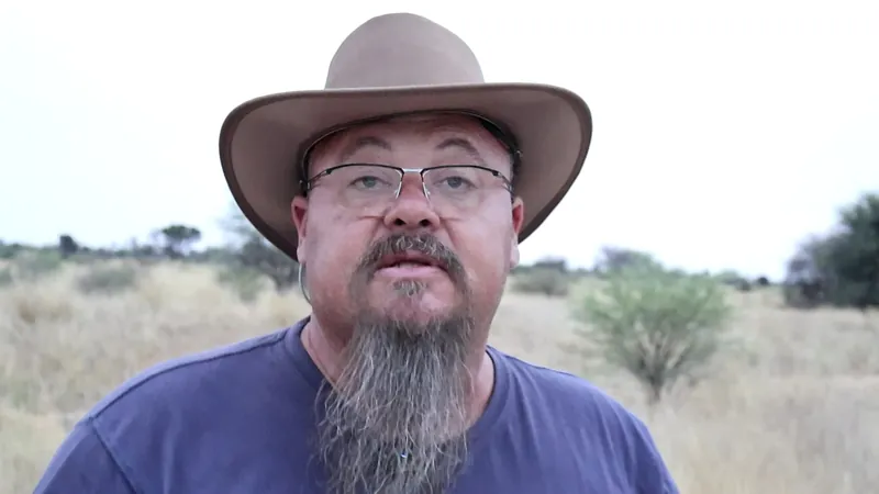 Corné Tewitz overlanding in the African bush at golden hour wearing a wide-brim hat